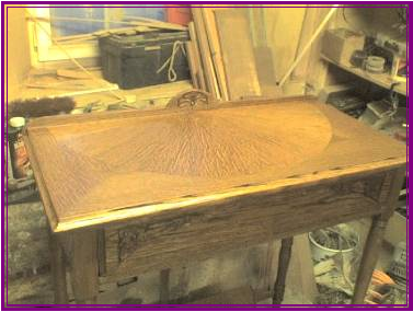 A Detail picture of the small Oak hall table showing the semi circle veneered top